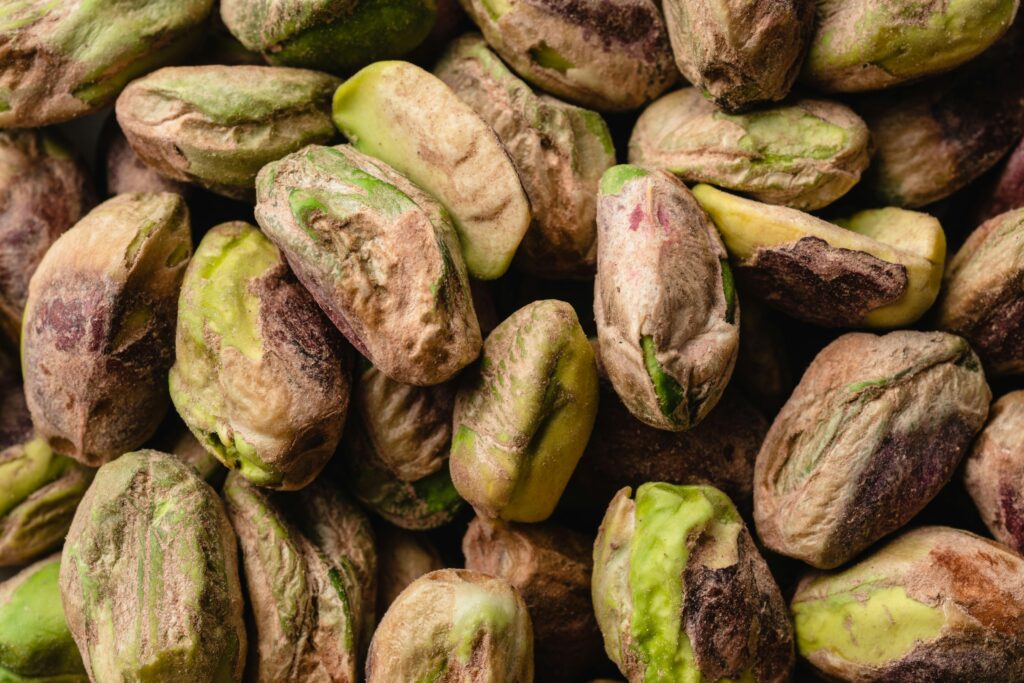 Macro shot of unshelled pistachios showcasing natural texture and colors.